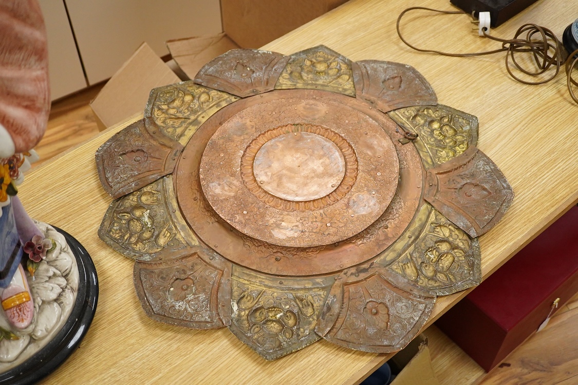 A large Nepalese brass and copper embossed tray, first half 20th century, set with simulated turquoise cabochons, 68cm diameter